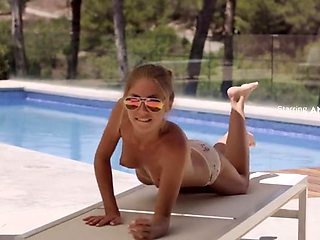 Teen beauty oils up her sexy slim body and poses poolside