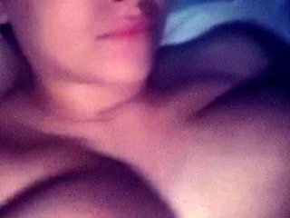 A super sexy brunette massages her big boobs