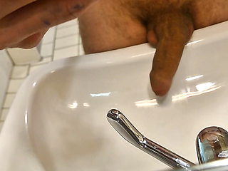 He pisses in the sink with his huge cock