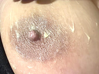 Hot sexy blonde fills her huge nipple with cream