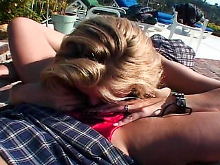Redhead and blonde MILF having lesbo fun by the pool
