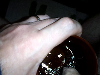 John is taking a piss in his coffee mug