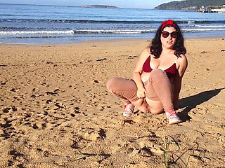 Woman Pissing on a Public Beach While No One Is There