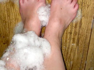 Teen's feet are caressing in foam