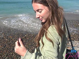 Busty teen Macy Meadows shows off her tattooed ass and long hair in the sand