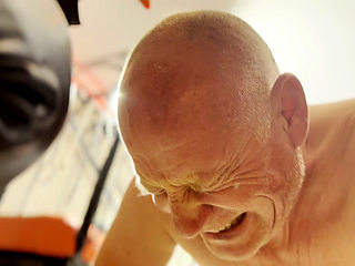 Hot waxing the bald head of the prisoner