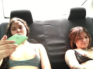 Two hot girlfriends masturbate in the car.