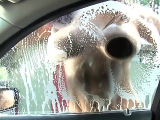 Sexy and wet girl washing car gives a good boobjob