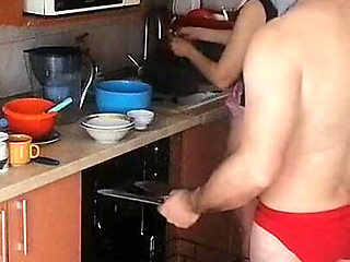 Couple Having Fun in the Kitchen. Sexy Wife Doing Chores in the House Naked
