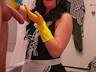 Chubby Milf Maid Bound Ember, gives handjob to hotel guest in rubber gloves then takes a cumshot facial