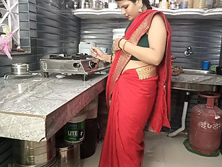 In the kitchen, the brother-in-law made the beautiful sister-in-law in red saree do the doggy style and fucked her.