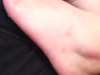 Worshiping the feet of a tattooed gothic lady