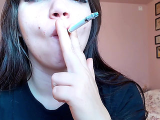 Big luscious lips with natural color lipgloss smoking cigarette