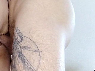 A girlfriend with a big ass stands doggy style and takes a dick in her pussy