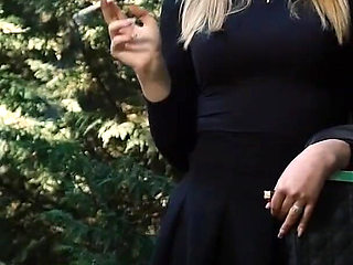 Hot Blonde Babe Smoking One Black Cigarettes in Nature