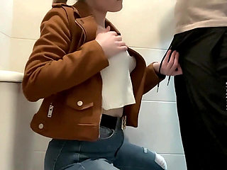 Busty Blonde Sucks Cock in the School Bathroom