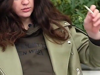 Young Brunette Is Taking an Unhurried Stroll with Allwhite 120mm Cigarette