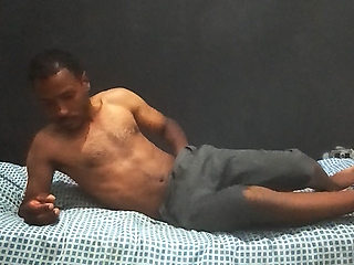 Brunette man in his bedroom masturbating