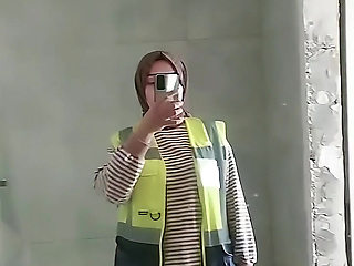 Turkish girl with headscarf who turns on the camera and puts on a show at the construction site