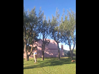 Stepmother in a Bikini in the Garden of the House Makes a Video for Her Stepson, to Show off Her New Clothes.