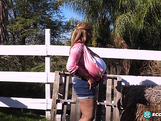 Africa gets out her giant tits outdoors and plays with her