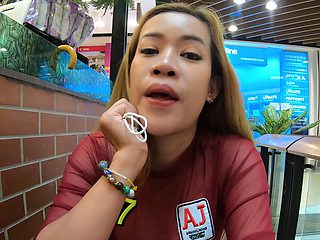 Asian babe flaunts phony boobies in skimpy attire while getting a naughty hand job under the sun
