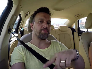 First hands on the steering wheel then mouth on the cock