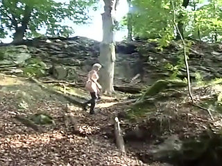 Lonely slave in fetish clothes walking in the woods
