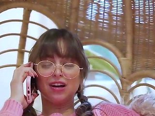 Petite brunette in pink sweater enjoys phone sex