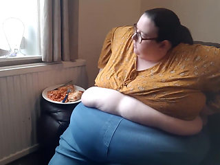 SSBBW huge belly whilst eating on sofa