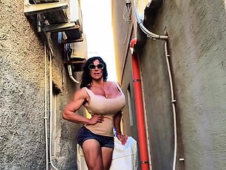 A super sexy brunette massages her big boobs