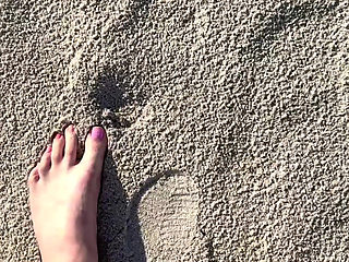 Comparing Size 16 Feet to Sand Prints at the Beach