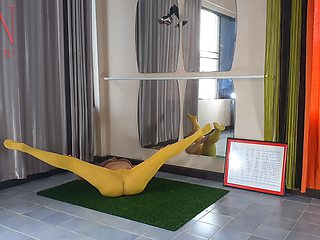 Regina Noir. Yoga in yellow tights doing yoga in the gym. 3