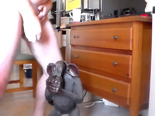 John is peeing on an ape statue