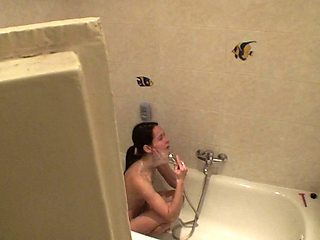 Sexy brunette teen is taking a shower