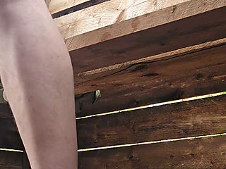 Riding a big dildo on a high seat in the forest