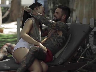 Asian beauty Katana gives a blowjob to a hung tattooed guy before outdoor action