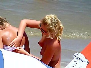 Topless teens showing young firm boobs and puffy nipples on the beach!