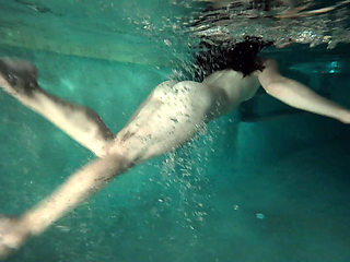 redhead girl swimming naked in pool