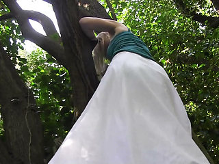 She climbs on tree and fingers her pussy