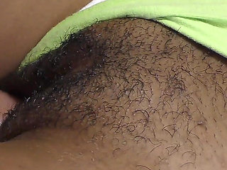 Close-up of a black hairy cunt filled with hot jizz