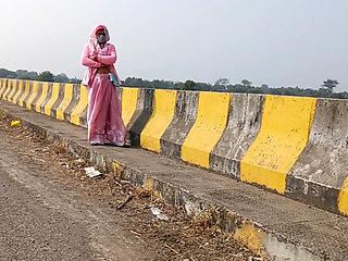 Sister-in-law is walking on the bridge by the roadside, getting down on the shore, sister-in-law started taking her clothes from the toilet and fingering her pussy.