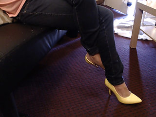 Double crossed yellow pumps dangling