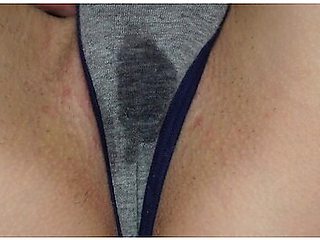 Wet panties betray her arousal as she touches herself