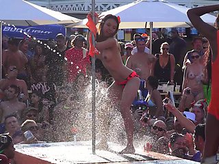 Mature Blondie flaunts her fakes in a skimpy bikini at the beach