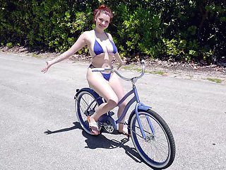 Annabel Redd is riding the bike and showing off her big boobs