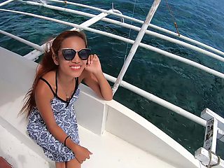 Asian babe with natural tits and long hair craves your cock in a secluded beachside blowjob
