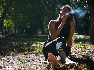 Seductive Russian Beauty Smoking Cigarette in Studio